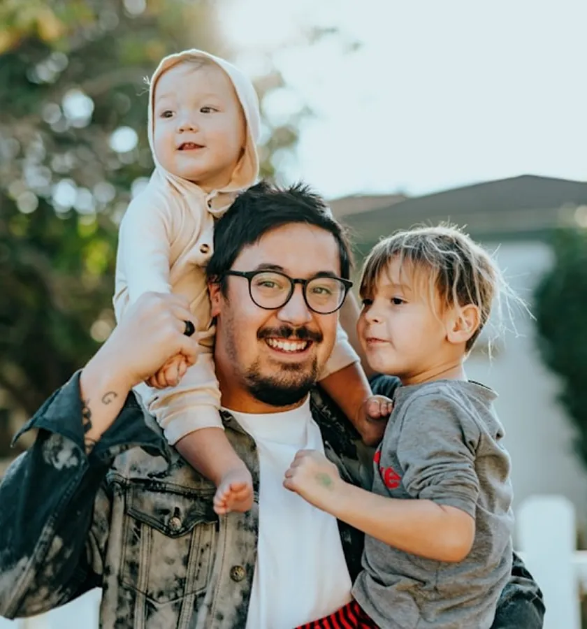 A father carrying his two children