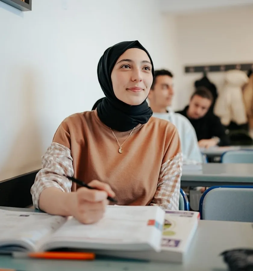 A student smiling in a classroom