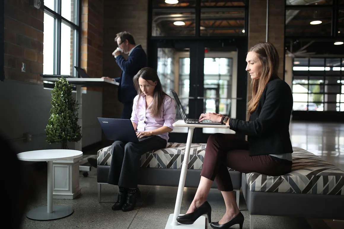 People working on laptops around a table