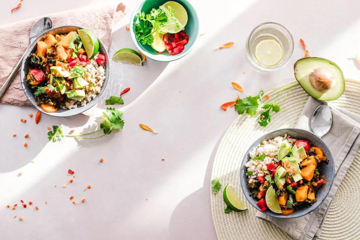 Bowls of colourful salad with avocado