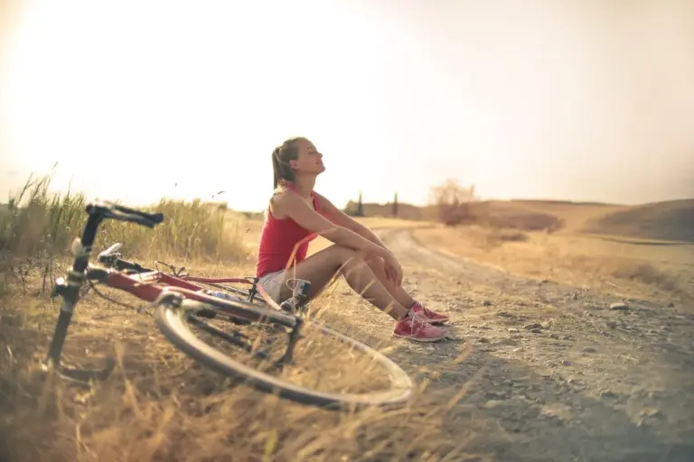 A cyclist resting in a sunny field