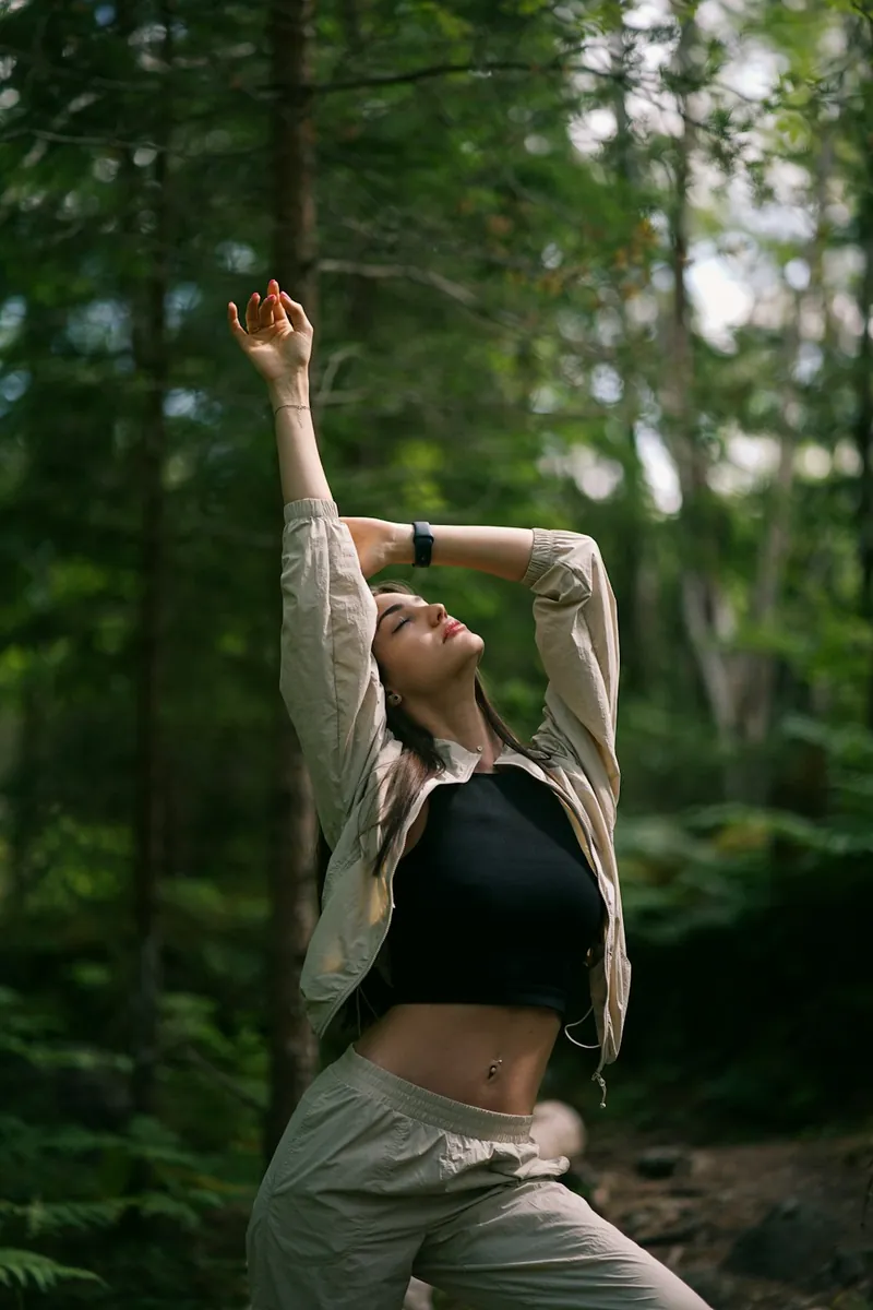 A woman stretching in a forest