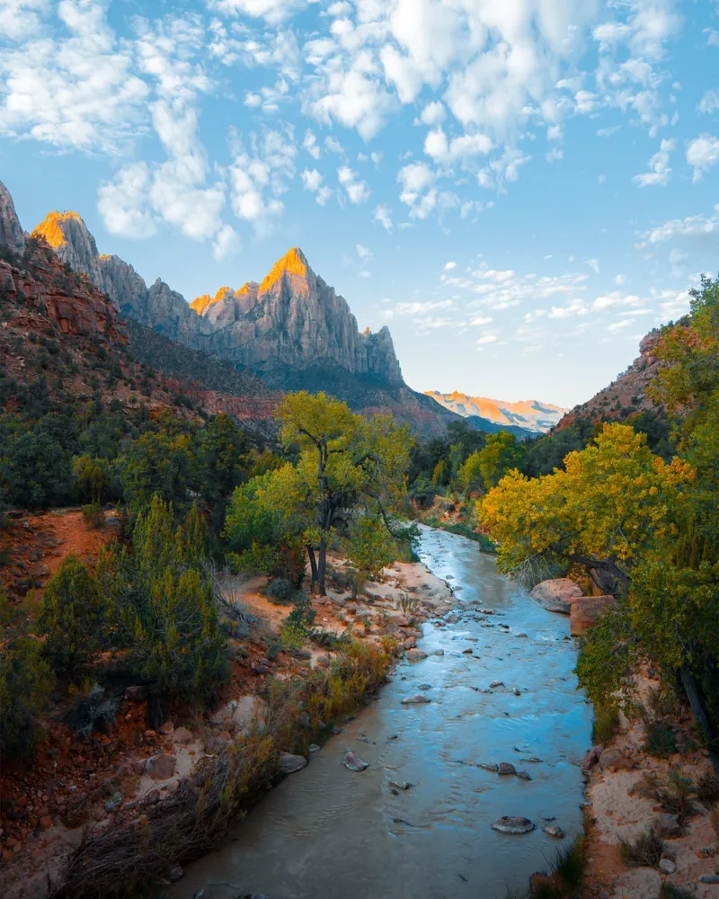 A river running below red mountains