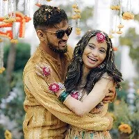 Haldi ceremony with the couple covered in turmeric and marigolds