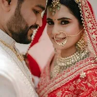 The bride and groom at the wedding ceremony in red and ivory