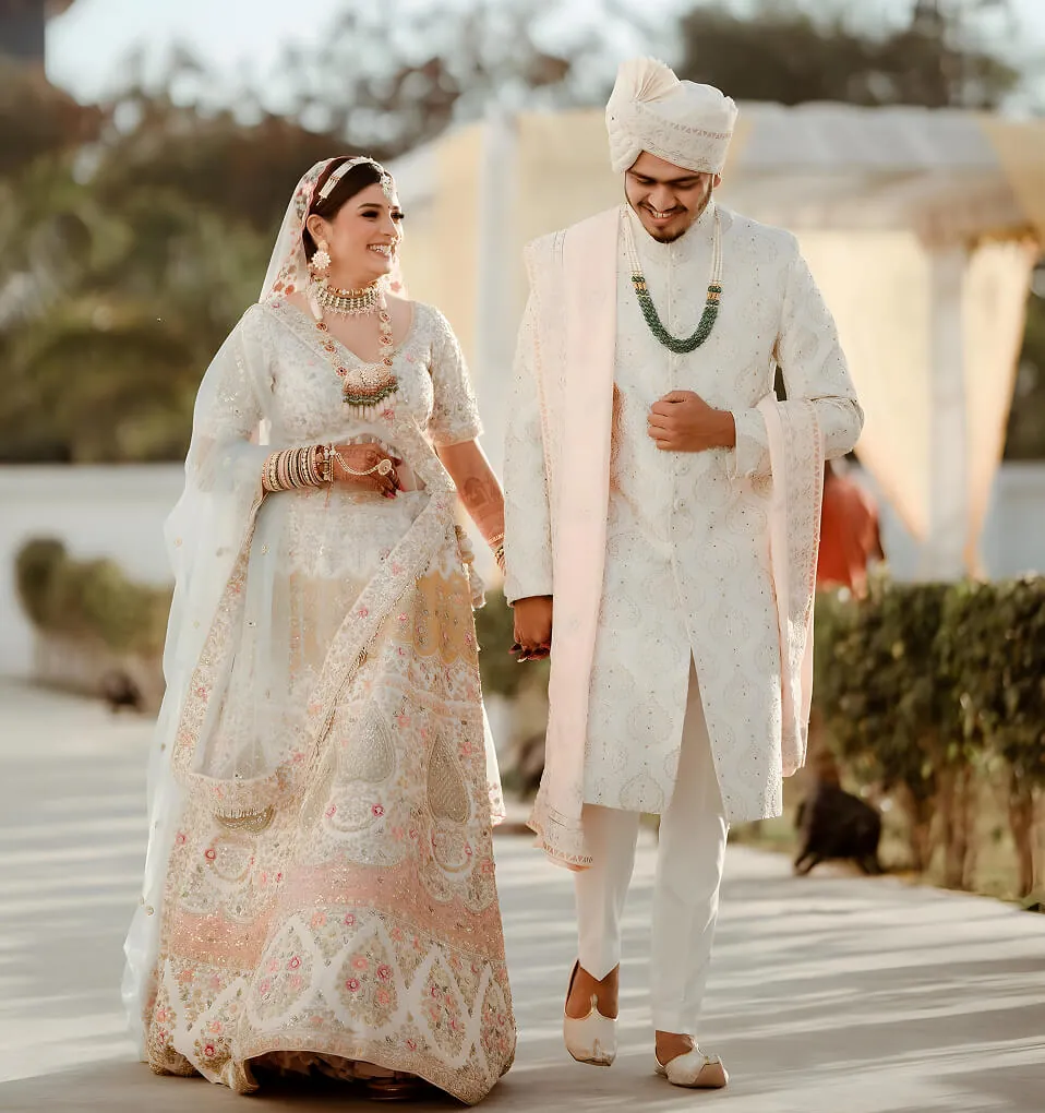 Yash and Dipika walking together in their wedding outfits