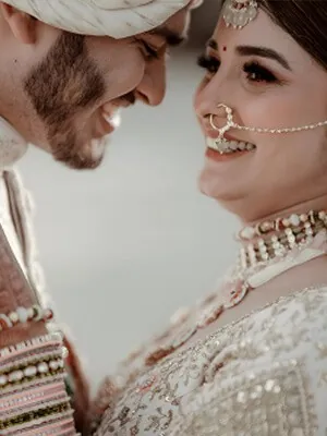 Bride resting against a sunlit wall in gold bridal wear