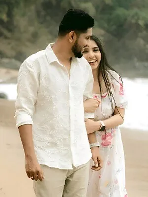 Bride and groom holding hands forehead to forehead