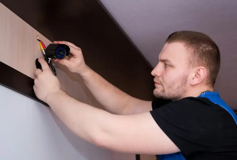 An electrician fitting a ceiling light