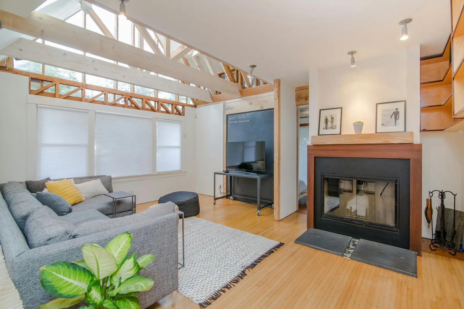 An open living room with a fireplace and track lighting