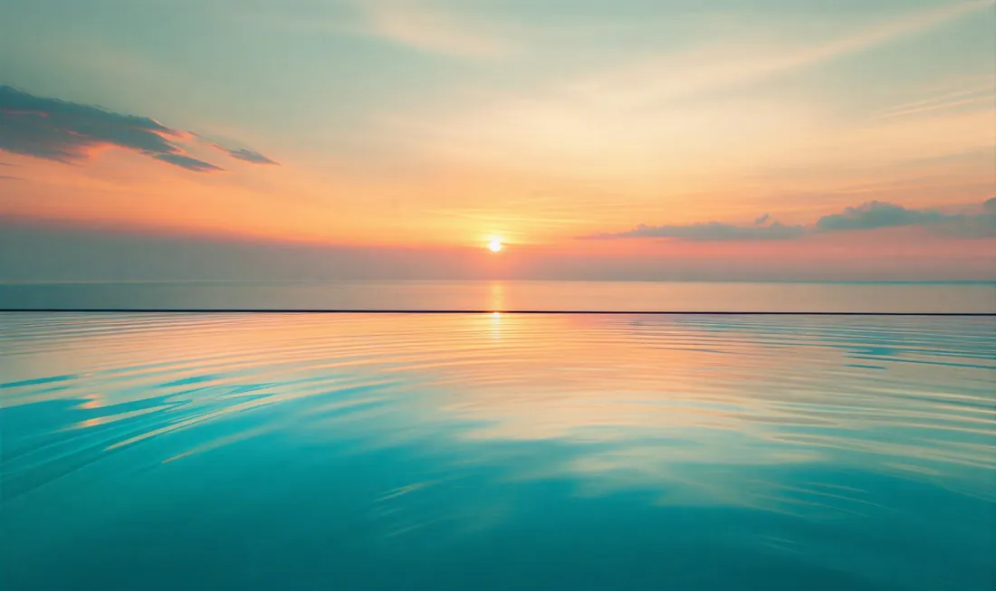 The sun setting over a calm sea
