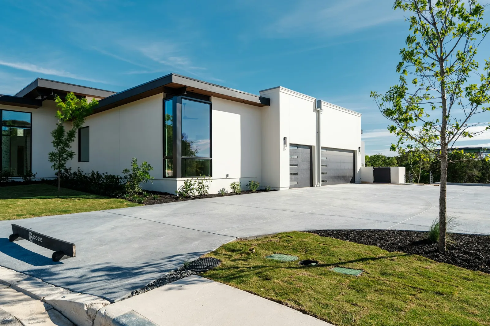 Freshly cleaned concrete driveway in front of a modern home