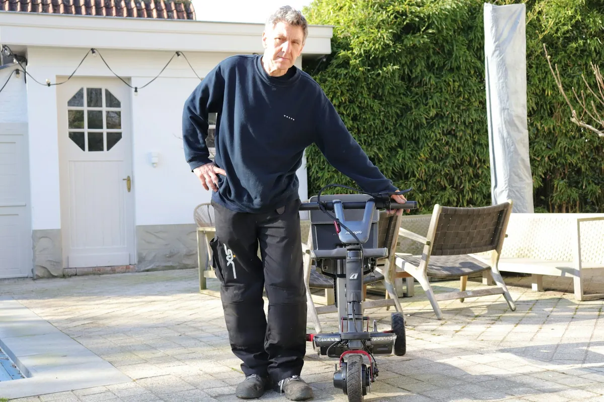 A technician with a pressure washer on a patio