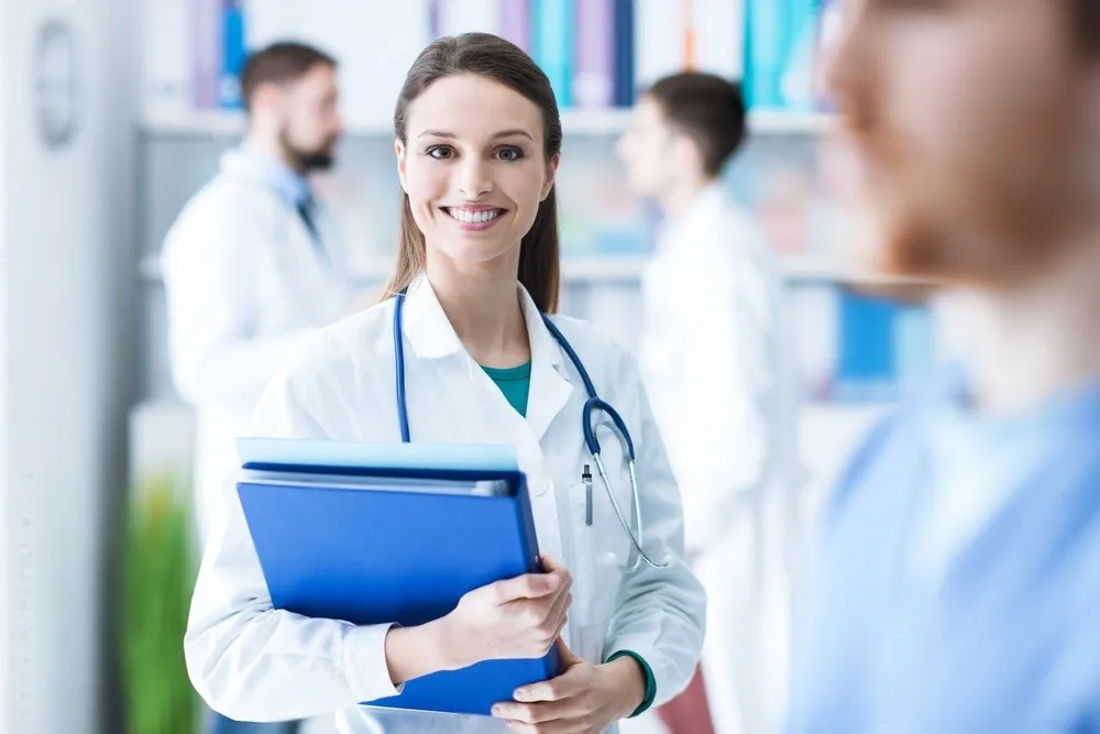 A doctor holding a blue folder