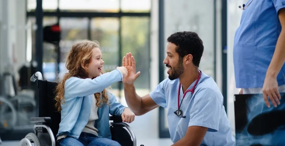 A girl giving her doctor a high five